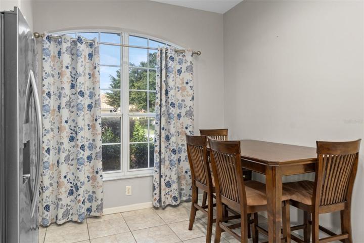 Eat in kitchen with window looking out to the front yard. The sink and breakfast bar are directly behind the photographer.