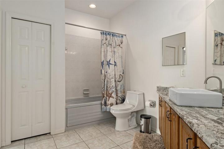 The Jack and Jill guest bath has its own linen closet and a jetted tub.