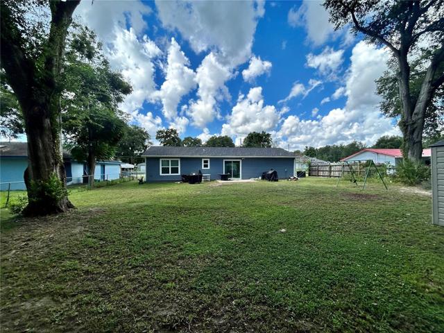 Rear view of home and backyard