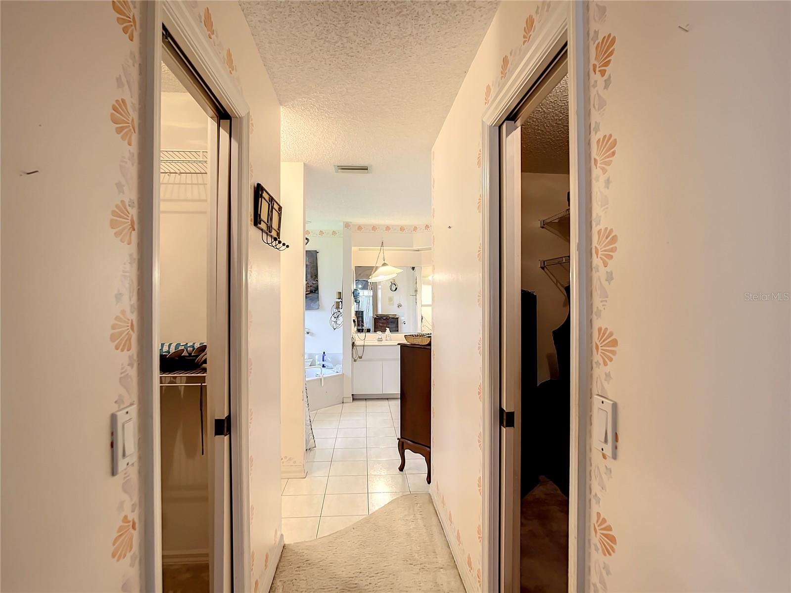 Master bedroom has his and hers closets leading to the bathroom.