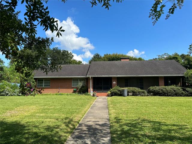 View of front of property, beautiful landscaping.