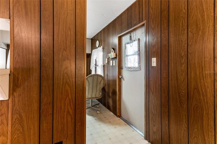 Front door looking from living room to kitchen