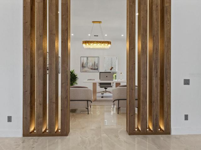 Behind a beautiful wood accented opening you have a flexible space to use as a home office, den or anything else your family might need! Virtually Staged.