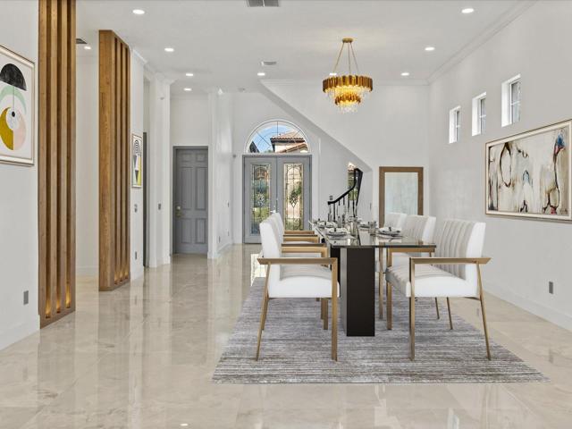 Stepping into the foyer take note of the light and bright open concept with sight lines straight through to the lake, high end oversized TILE FLOORS throughout and SOARING CEILINGS! Virtually Staged.