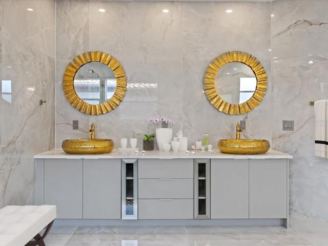 Your luxurious private bath delivers an array of gold accents, including an extended dual sink vanity, soaking tub and expansive shower with multiple shower heads, bench seating and must see tile work behind seamless glass doors! Virtually Staged.