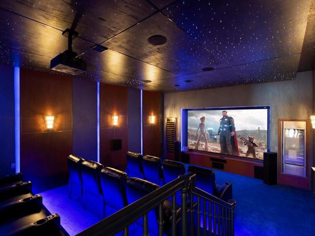 This home also boasts a CUSTOM THEATER ROOM with curated furniture, movie screen, surround sound system, projector and built in refrigerator!