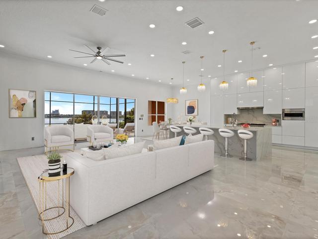 Your formal dining space flows naturally into the living room and modern CHEF’S KITCHEN with a wall of sliding glass doors that open wide for indoor/outdoor living and entertaining with gorgeous water views, and a breakfast nook for casual dining! Virtually Staged.