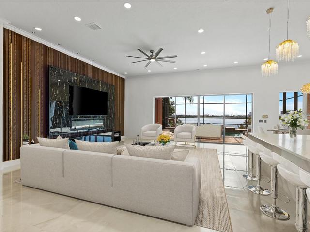 Your formal dining space flows naturally into the living room and modern CHEF’S KITCHEN with a wall of sliding glass doors that open wide for indoor/outdoor living and entertaining with gorgeous water views, and a breakfast nook for casual dining! Virtually Staged.