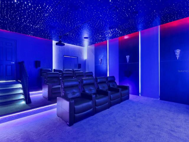 This home also boasts a CUSTOM THEATER ROOM with curated furniture, movie screen, surround sound system, projector and built in refrigerator!