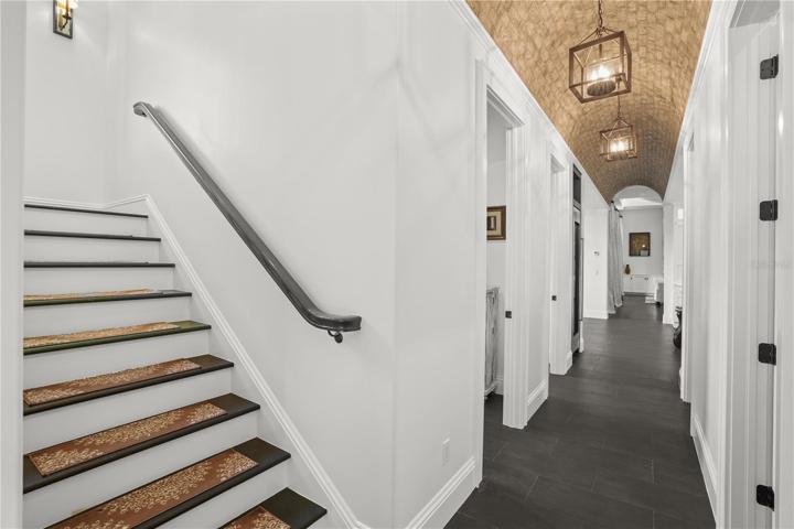 Back stair case leads back to hall by kitchen