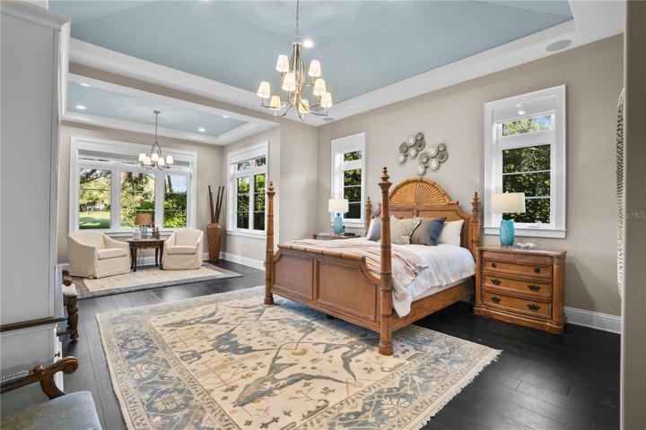 Primary suite offers vaulted ceiling,