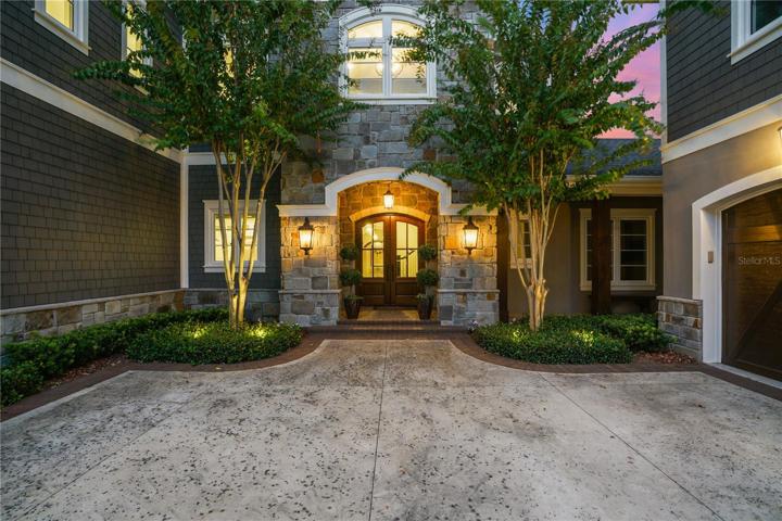 Pavered courtyard with 4 car garage