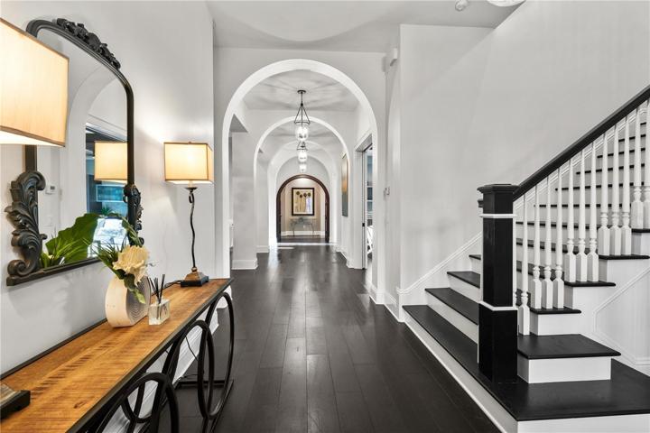 Arched hallway leads to primary suite