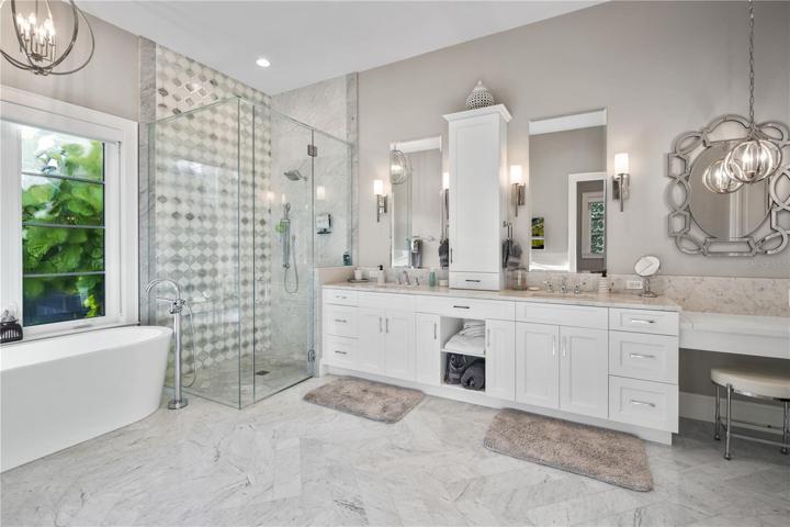 Primary bath features marble tile floors