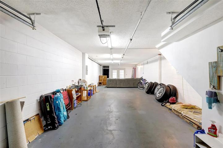 The attached garage of this townhome. It's a practical and secure space to store your vehicle, keeping it protected from the elements. With ample space for storage, it's not just for parking but also for keeping your belongings organized.