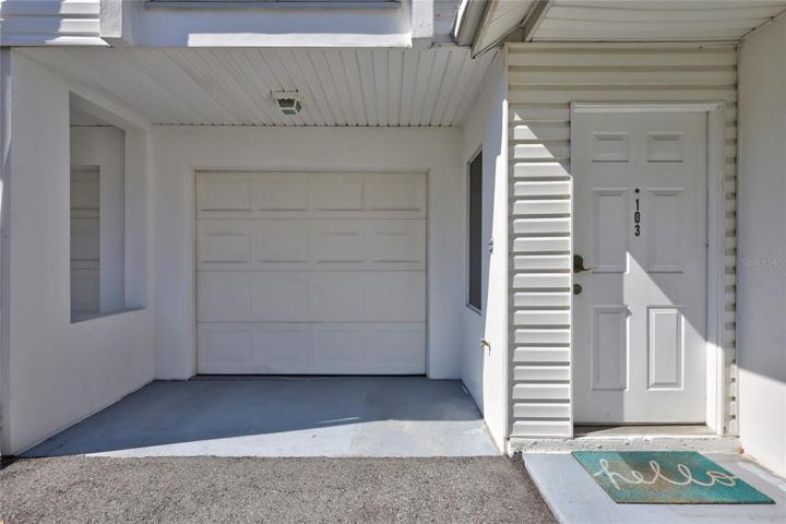 The front entry of this charming townhome, complete with a convenient garage door.