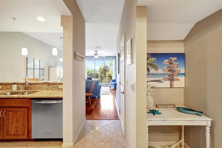 As you step into this townhome, you'll be greeted by a hallway that offers a lovely view of the path leading to the kitchen, dining area, and living space.