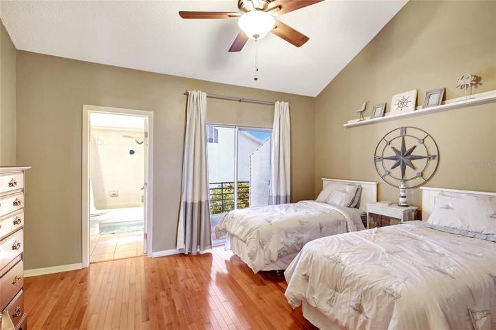 One of the bedrooms in this townhome, is thoughtfully designed with two beds for flexibility and convenience. It's an ideal space for accommodating guests or family members.