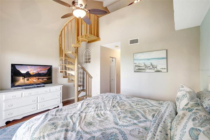 In the primary bedroom of this townhome, you'll discover a unique feature - circular stairs that lead to a charming loft.