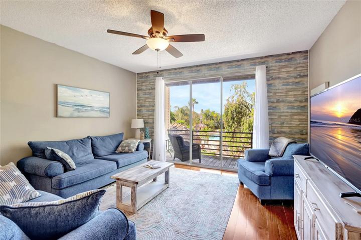 The living room of this townhome features a large sliding glass door that floods the space with natural light. This room is the epitome of comfort, offering ample space for relaxation and entertainment.