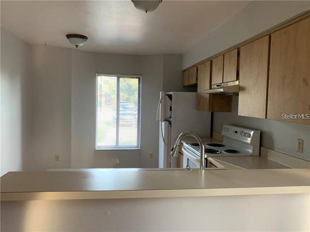 View of kitchen with large window.
