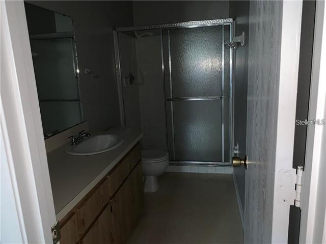 Primary Bathroom with stand up shower and sliding doors.