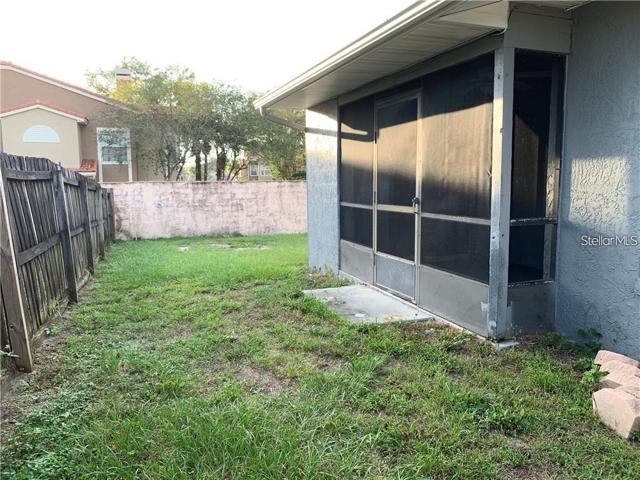 Screened in patio leading toward backyard.