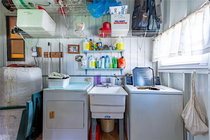 Laundry area is located off Florida room in storage room.