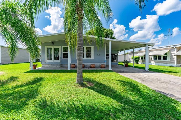 Well maintained home has three palm trees in the front yard.