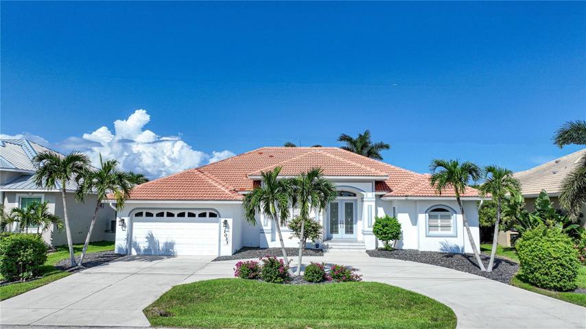 Stunning curb appeal with beautiful landscaping and circular driveway create a welcoming entrance to this home