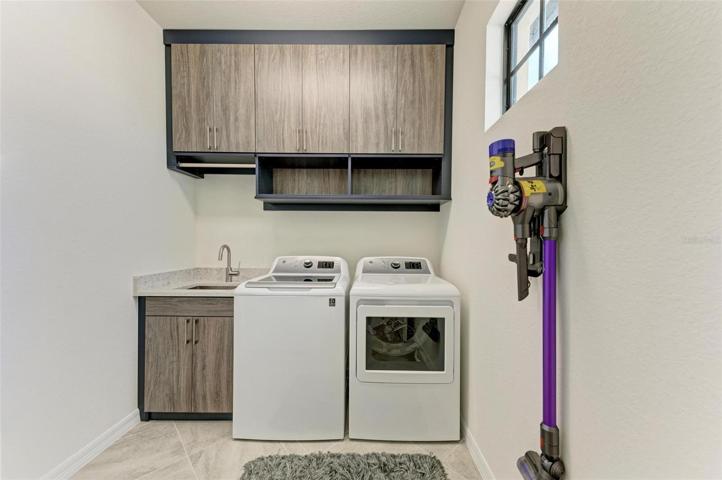 CUSTOM NAVY CABINETRY WITH SOFT CLOSE, UPGRADED WASHER & DRYER, CUSTOM QUARTZ COUNTERTOPS