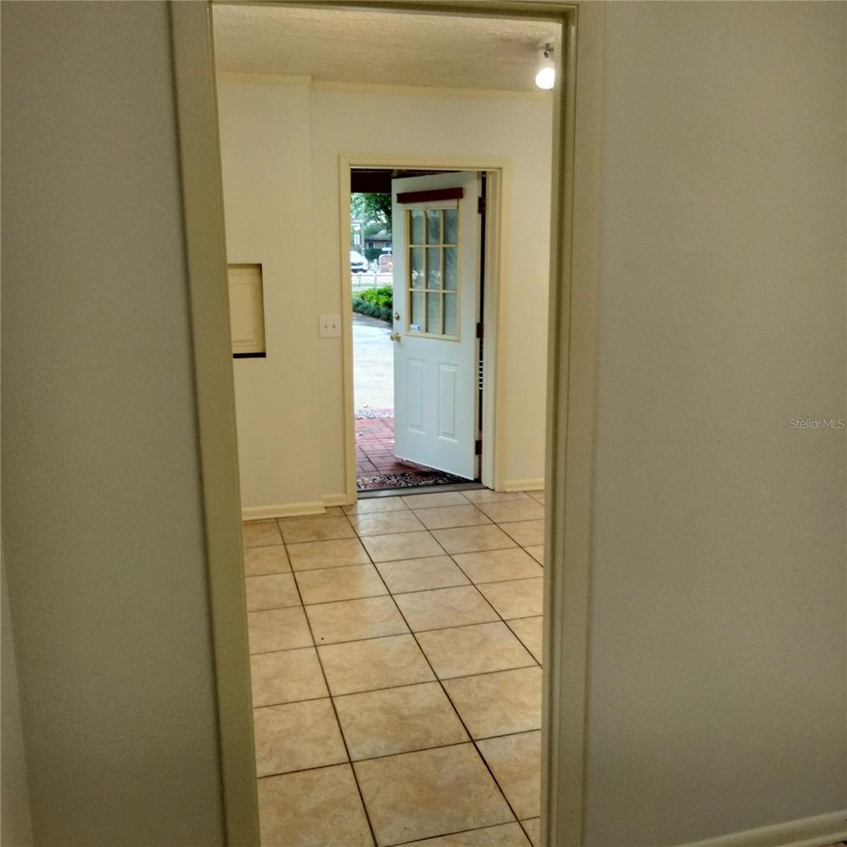 Looking from office into main room and front door