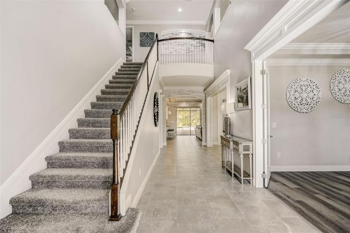 Foyer with soaring 22ft and  grand staircase to 2nd floor