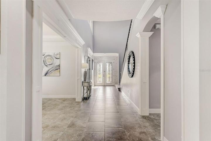 Foyer with soaring 22ft ceiling and double glass door entry