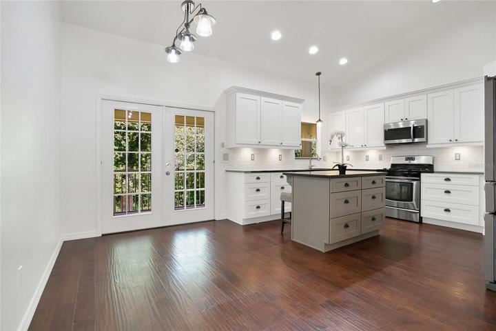 updated kitchen with shaker cabinets and gas stove
