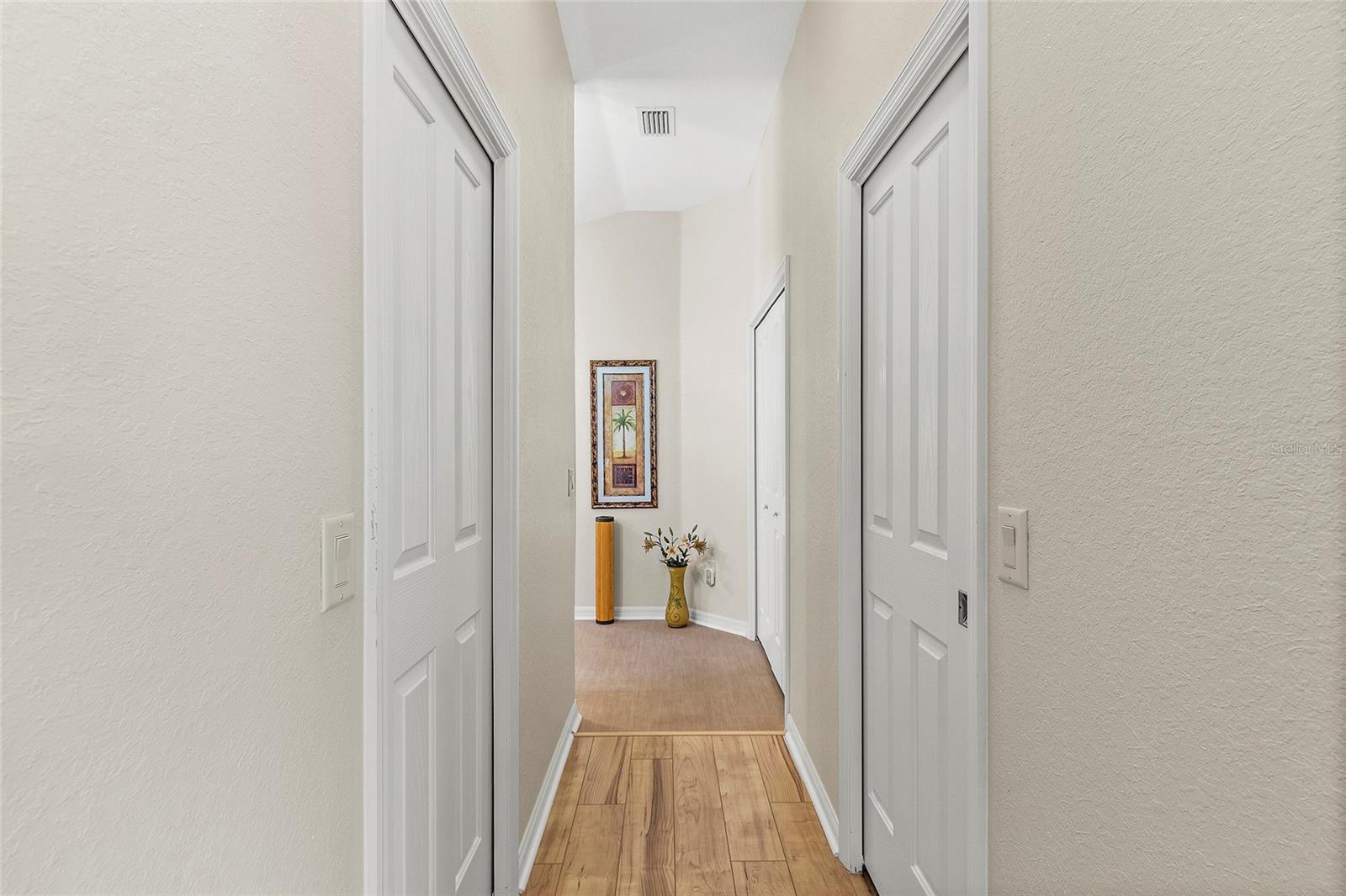 Hallway to Master bath with His and Her closets