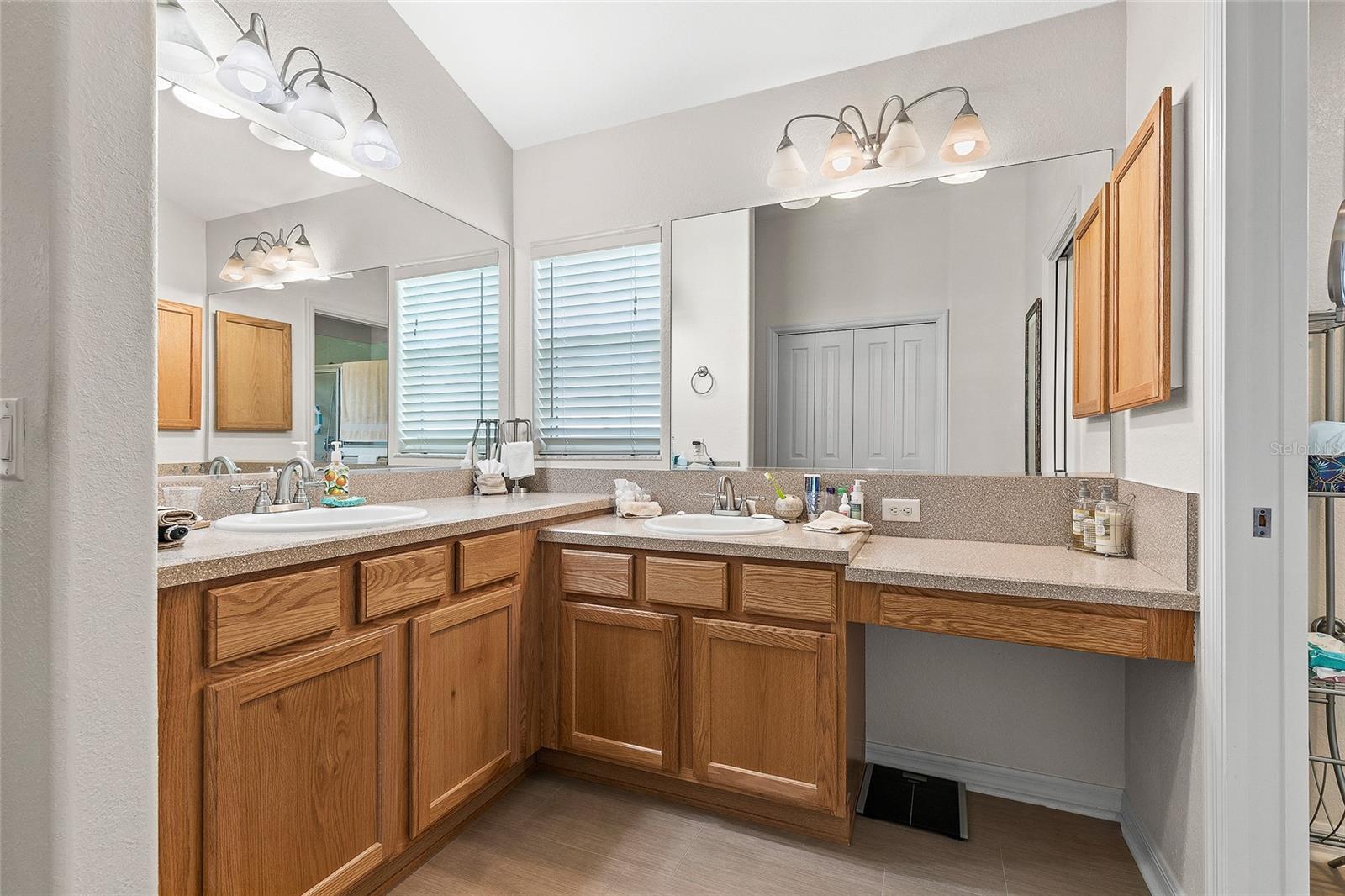 Dual vanities with dressing table in Master
