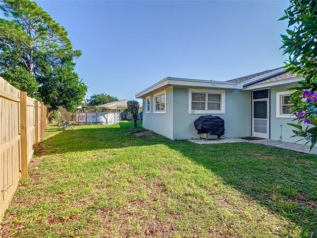 Back yard has a wood privacy fence around it.