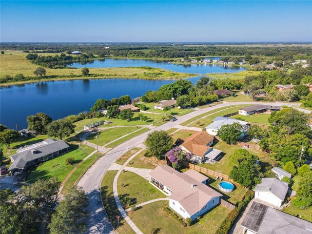 This home sits on a corner lot of Ridge Manor and Strathmore Place.  You can enjoy a relaxing view of “Lake Belle” from your side screened lanai.  Located on a 1/4 acre lot with privacy fenced back yard and back-yard above ground pool.