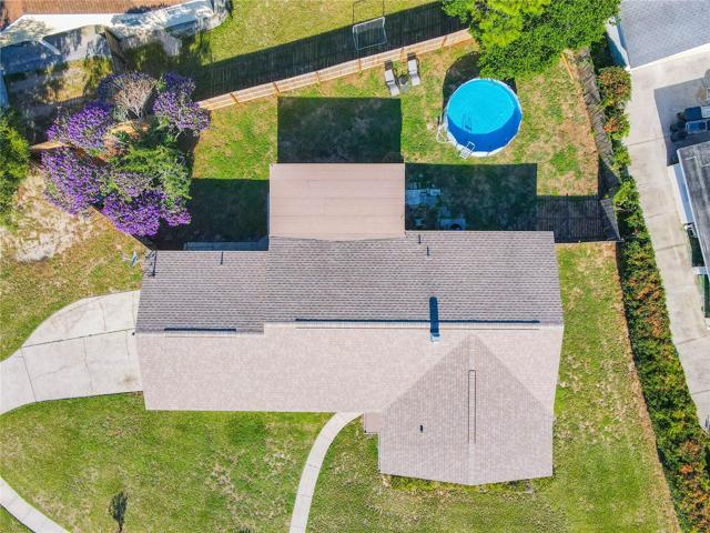 Aerial view of the home shows the back yard space with above ground pool.