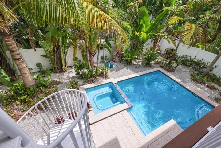 Spiral staircase down to pool from back porch