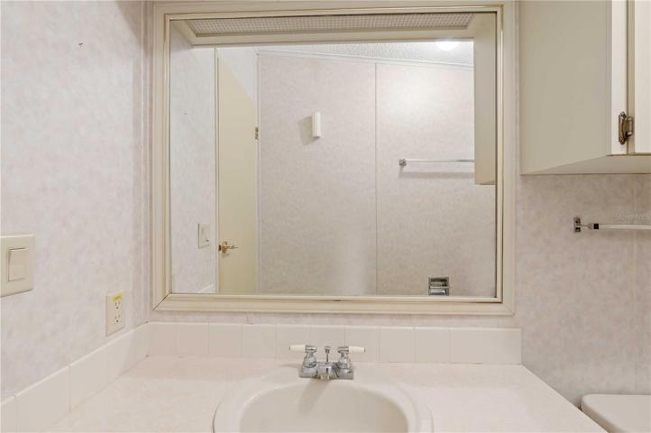 Guest bath has tub/shower combo.