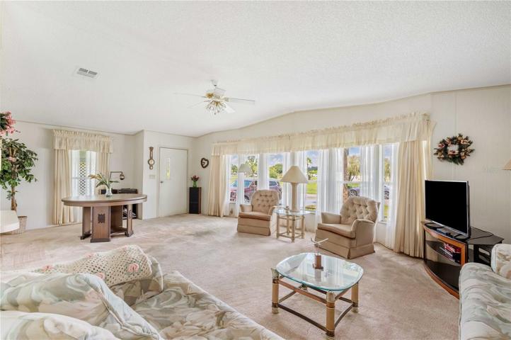 Living room is open concept with high ceilings.