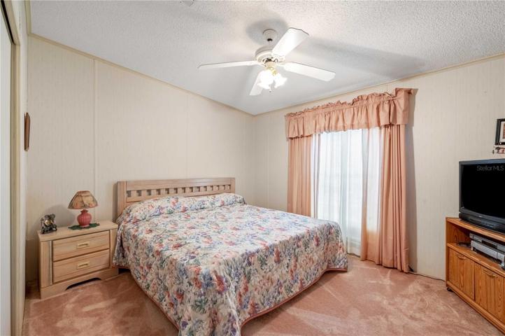 Bedroom #2 has ceiling fan, built-in closet, and carpeting.