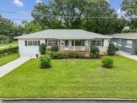 Large landscaped lot with mature trees.