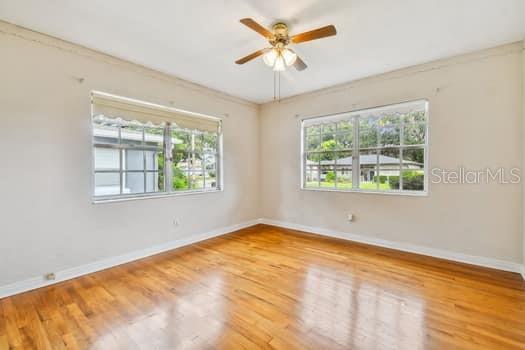 Bedroom 3 with hardwood floors and lighted cedar closet.