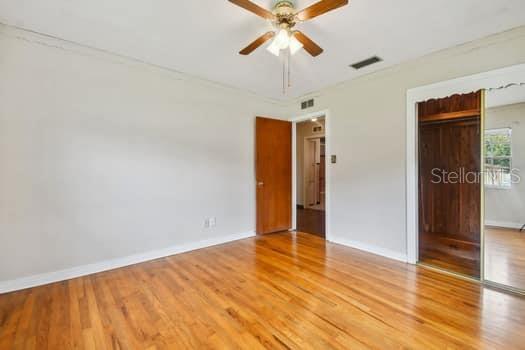 Bedroom 2 with hardwood floors and lighted cedar closet.