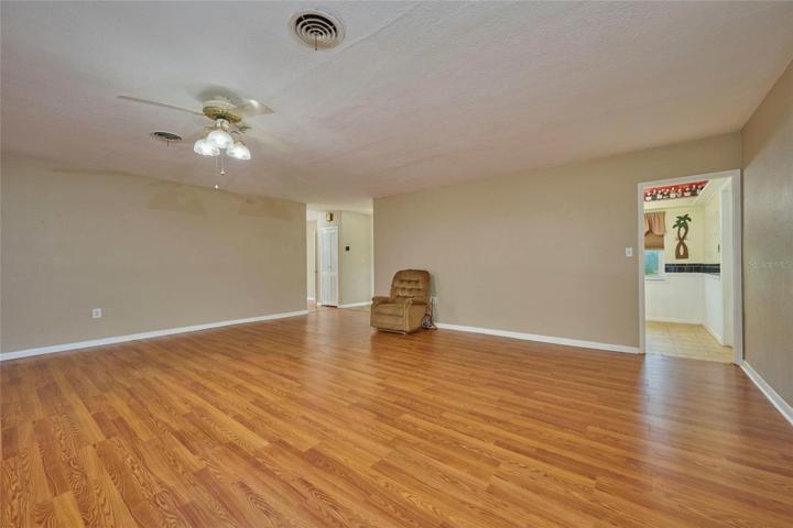 Reverse view of the great room. Doorway to the right leads into kitchen.  Doorway to the left leads to foyer and bedrooms.