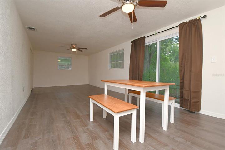 The kitchen overlooks dining  and family room that come with sliding glass doors leading to the outside and allowing for seamless indoor-outdoor living.