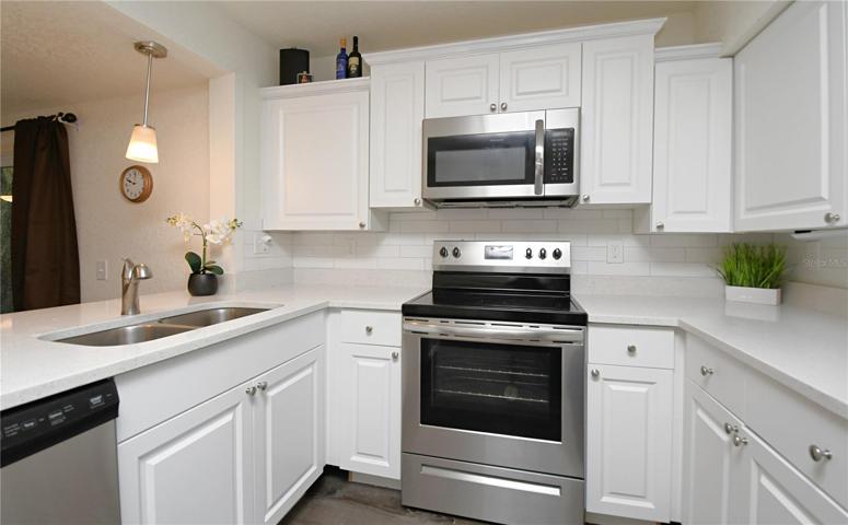 The kitchen offers plenty of cabinet space.
